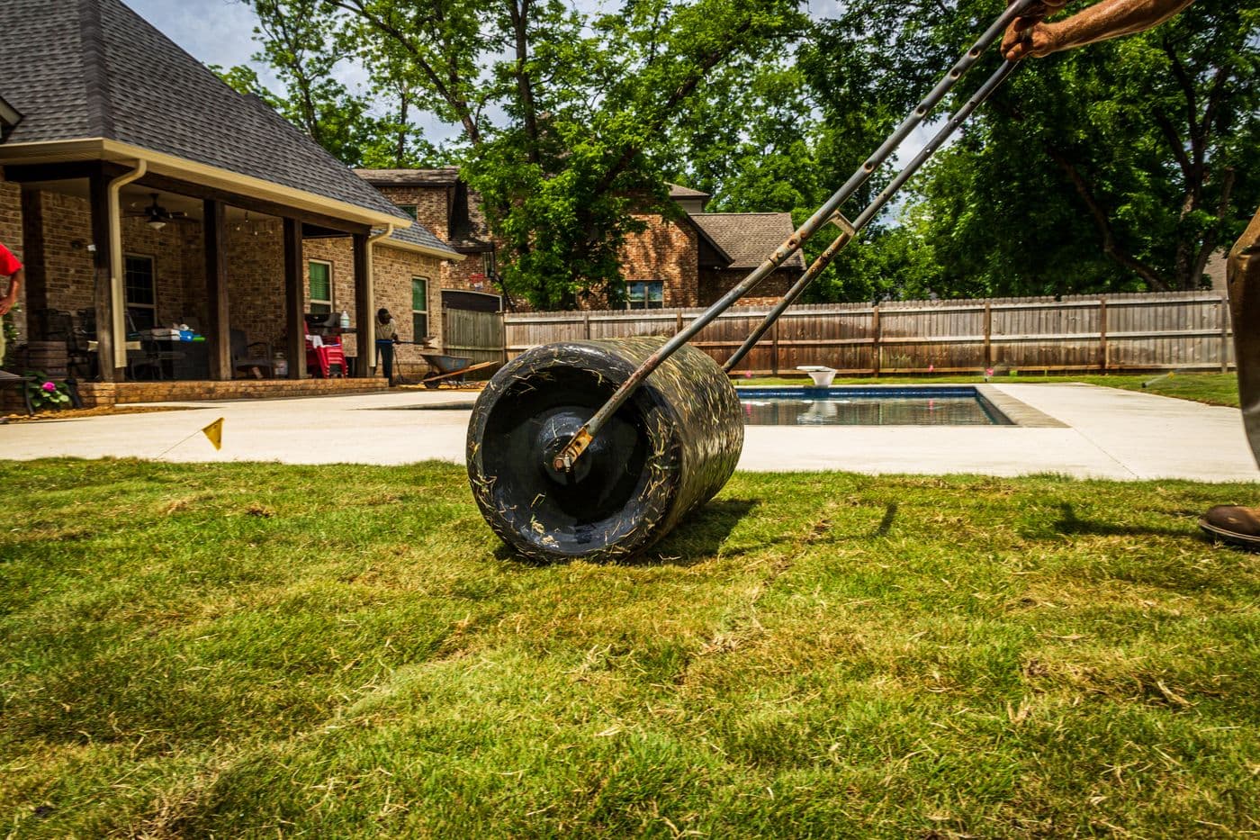 Crew installing fresh sod in a residential backyard